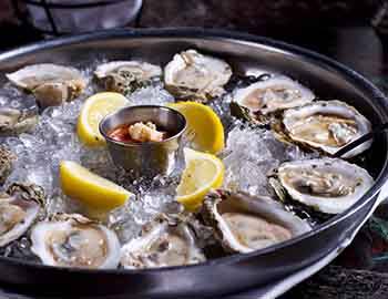 Fresh oysters on ice with lemon