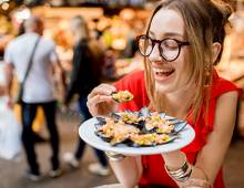 Woman eating mussels at a seafood restaurant